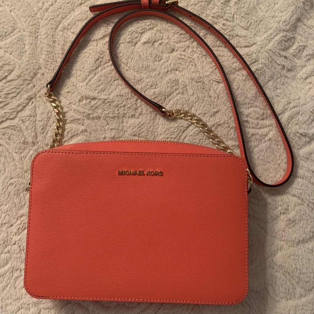 Coral East West Crossbody with a matching wallet.